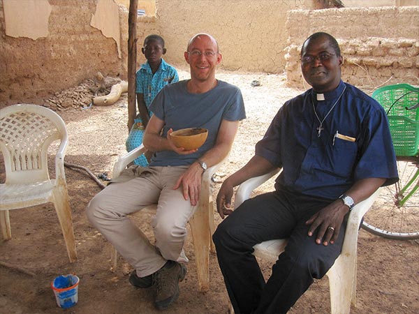 Anthony Lusvardi drinking dolo with friends in Burkina Faso