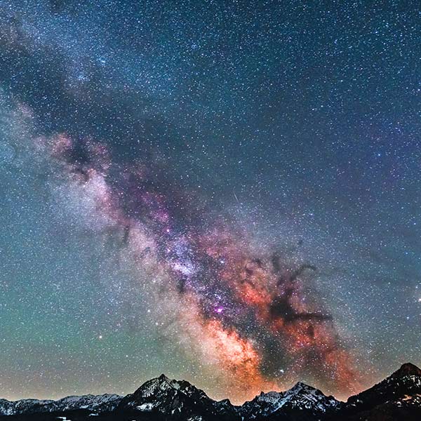 silhouette of mountains under a starry sky