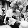 Albert Schweitzer holds two newborn babies at the hospital he founded