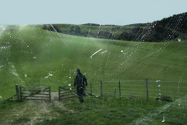a farmer walking through a gate