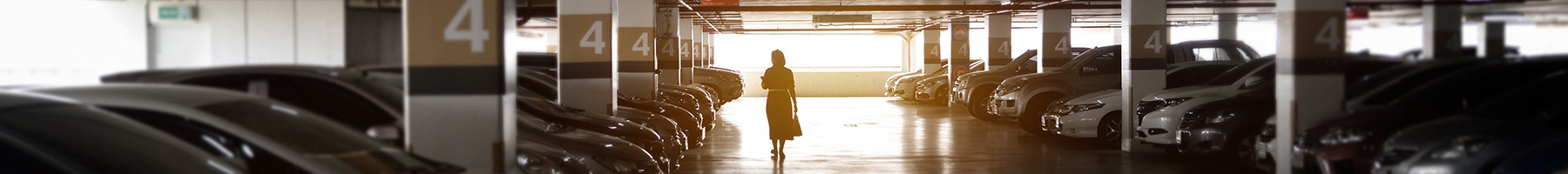 Woman walking alone in a parking garage