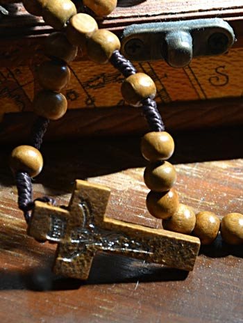 A wooden rosary with a cross