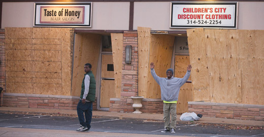 Plywood covered storefronts near the Ferguson police station in November, 2014. Businesses were bracing for possible vandalism if a grand jury declined to press charges against Darren Wilson, the officer who killed Michael Brown.  Photograph by Scott Olson / Getty Images