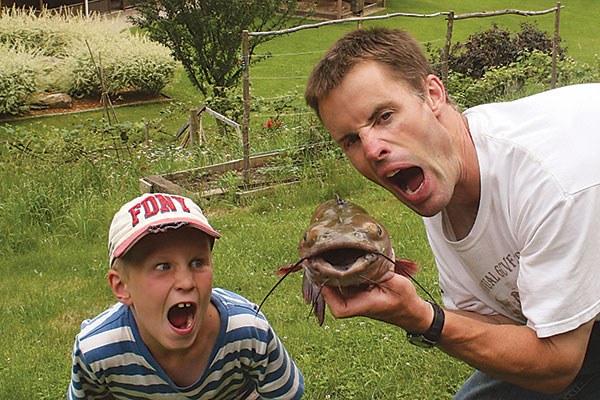 Father and son holding fish