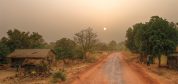 The sun shining on a dusty road in Africa