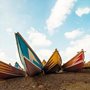 colorful boats on a shingle beach
