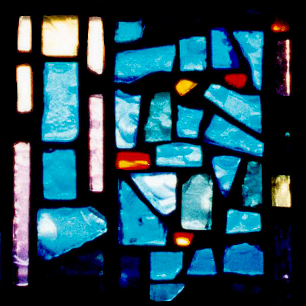 stained glass panel with blocks of blue, yellow, purple, and red glass