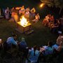 people singing around a campfire