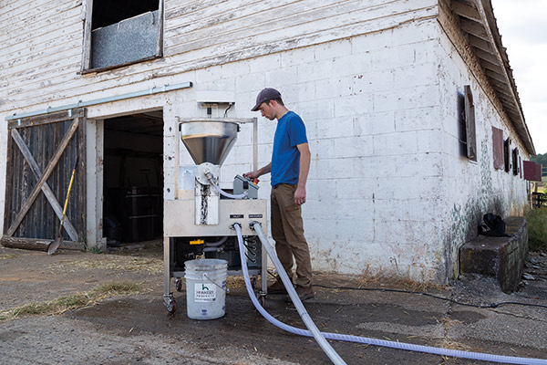 Hiwassee Products soil consultant at the controls of the Continuous Flow Bio-Extractor.