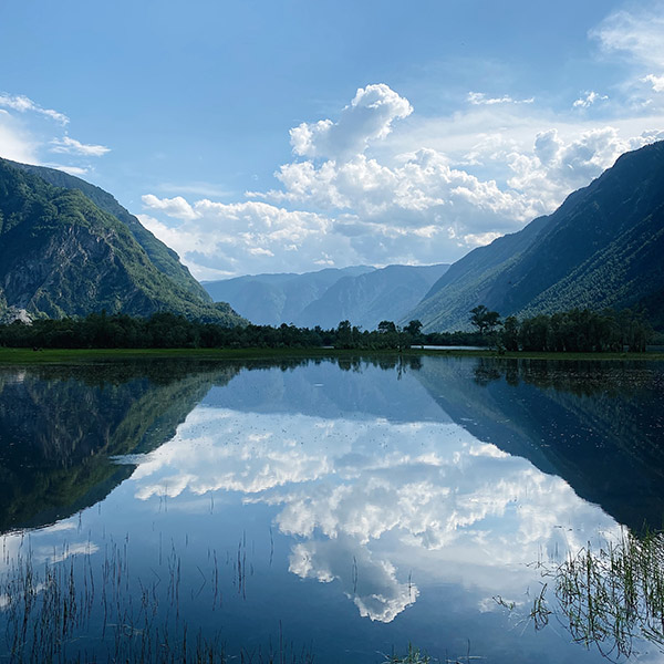 mountains and clouds reflected in a lake