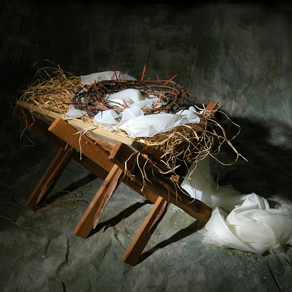 a manger, linen and a crown of thorns