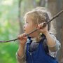 a young girl holding a branch of a tree