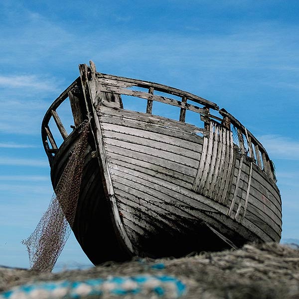 an old boat beached on the shore