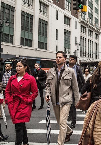 people walking across the street in New York City