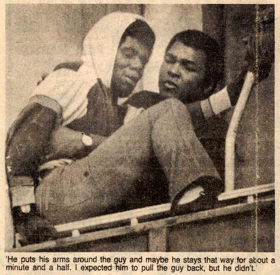 Mohammad Ali with his arms around the suicidal man.