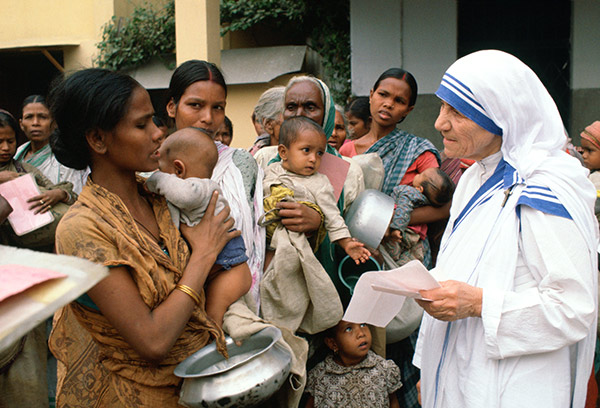 Mother Teresa with mothers and children at her Mission in Calcutta India