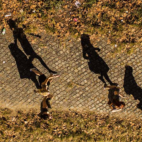 shadows of people walking on a path