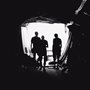 people silhouetted in tunnel entrance