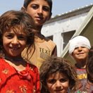 Four Iraqi refugee children in a camp