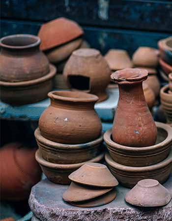 stacked brown pottery jars and bowls