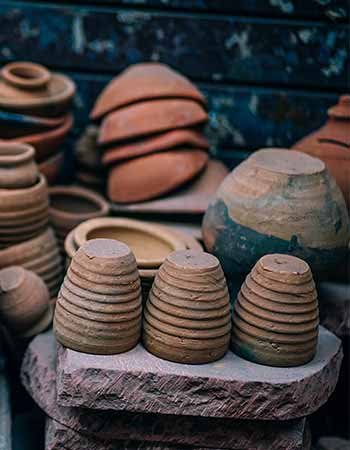 stacked brown pottery jars and bowls