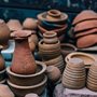 stacked brown pottery jars and bowls