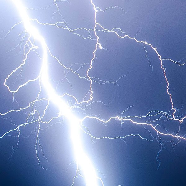 a white lightning bolt against a dark blue sky