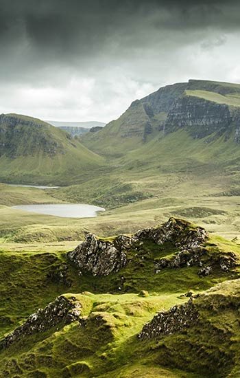 rocky hill and meadow with a lake on the Isle of Skye, Scotland