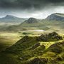 rocky hill and meadow with a lake on the Isle of Skye, Scotland