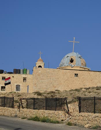 Bombed church building with two crosses