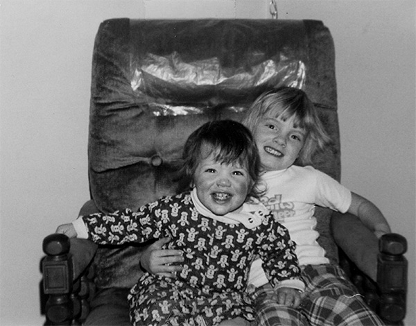 two girls sitting in an armchair