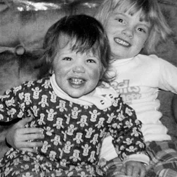 black and white photo of two kids laughing