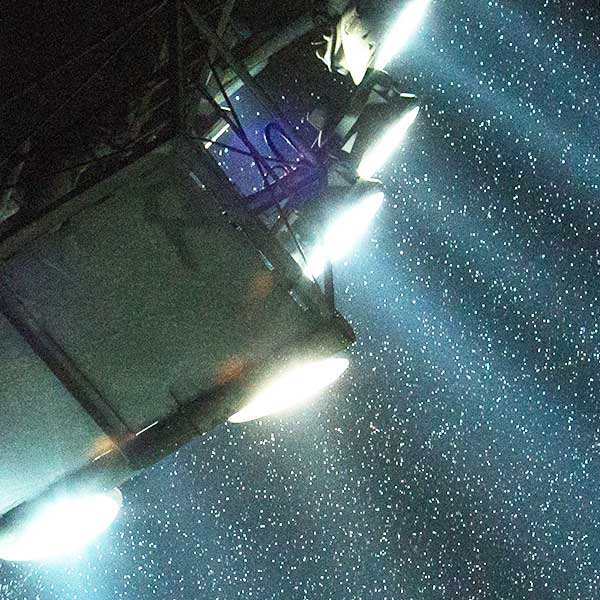 football floodlights shining through rain