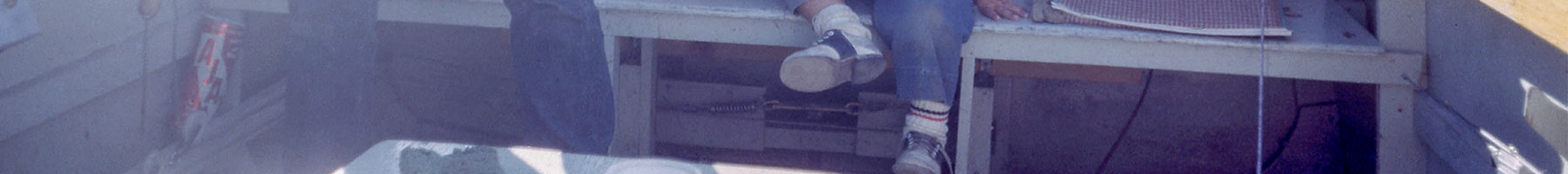 the feet of a boy in a boat
