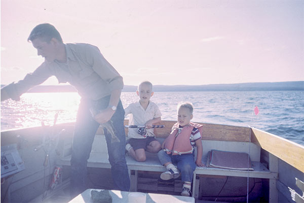 two boys fishing with their dad