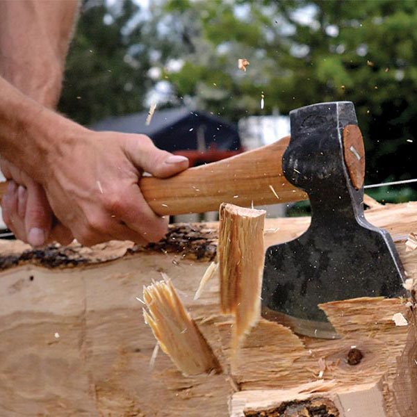 a man chopping a log with an axe