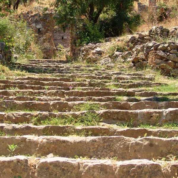 grass-grown stone stairs with stone walls on either side