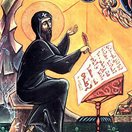 A medieval icon of St. Ephrem the Syrian, sitting behind a music stand composing hymns.