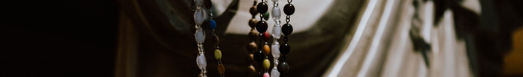 rosary beads held in a priest's hands