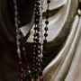 rosary beads held in a priest's hands