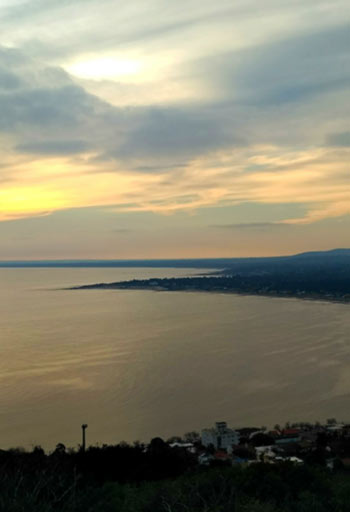 gold and blue sunset over a lakeshore
