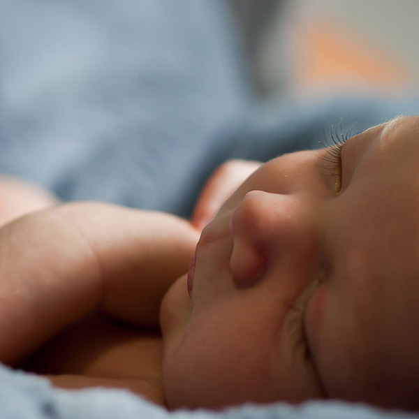 a baby sleeping on a blue blanket
