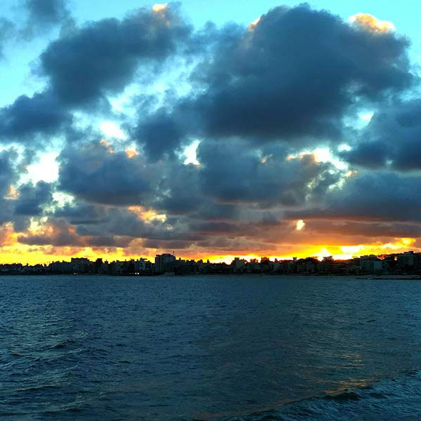 cloudy sky and sunset over a city