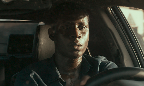 a young man driving a car