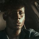 a young man driving a car