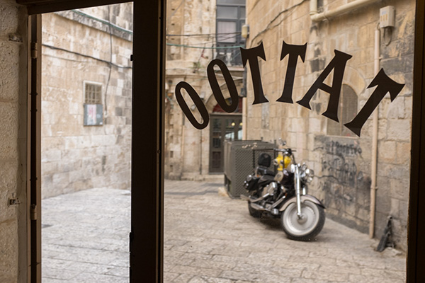Razouk Tattoo shop in Jerusalem with a motorcycle parked outside