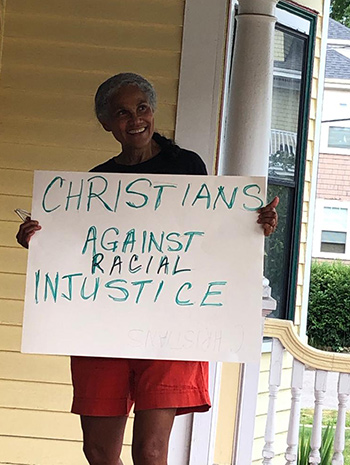 Jacqueline Rivers holding a sign