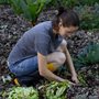 a man turning compost