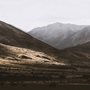 light shining on a dark mountain valley