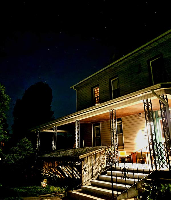 warmly lit front porch in Fox Hill